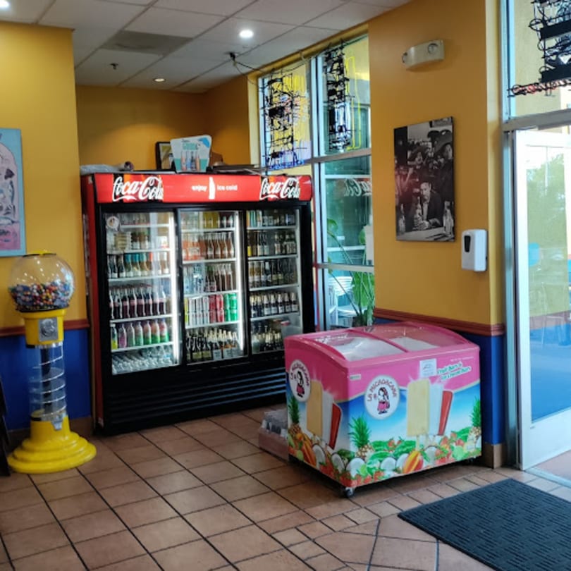 Interior of El Taquito Restaurant Dos with a Coca-Cola cooler, gumball machine, and ice cream freezer.